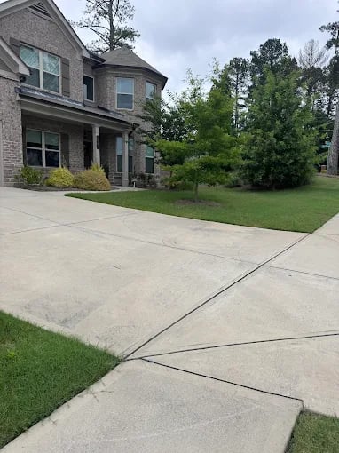 Well-maintained suburban home with manicured lawn and concrete driveway
